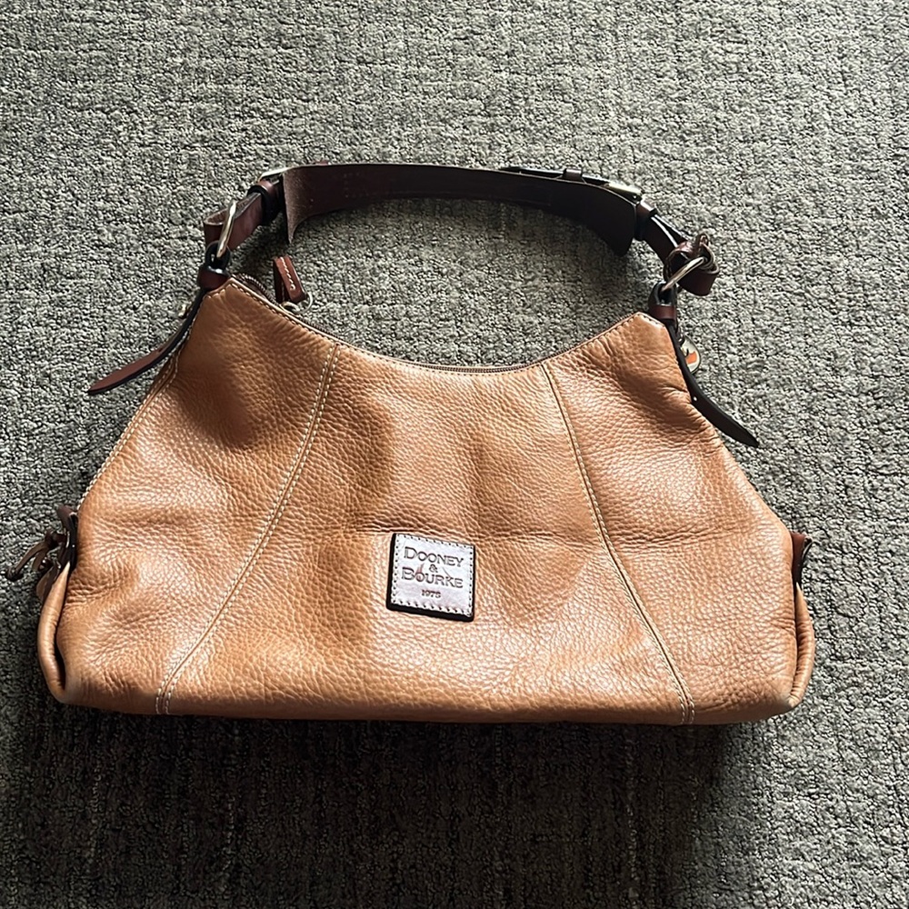 Dooney & Bourke tan with red lining pebble leather bag.